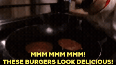 A Dog Is Looking At Burgers In A Frying Pan And Says " Mmmm Mmmm Mmmm " GIF