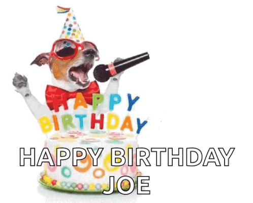 A Dog Singing Into A Microphone In Front Of A Birthday Cake . GIF