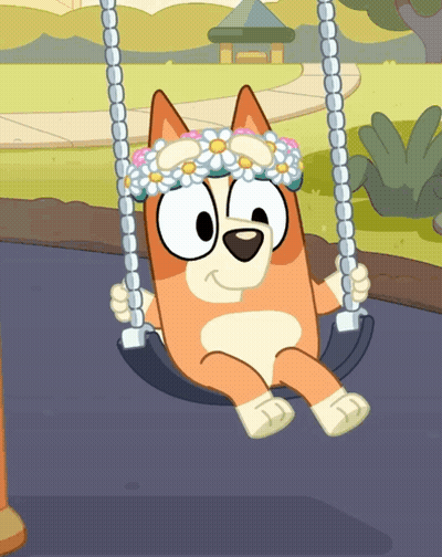 A Dog Wearing A Flower Crown Sits On A Swing GIF