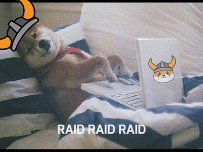 A Dog Wearing A Viking Helmet Is Laying On A Bed Using A Laptop GIF