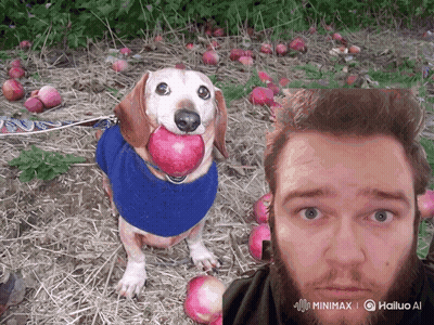 A Dog With An Apple In Its Mouth Next To A Man 'S Face GIF