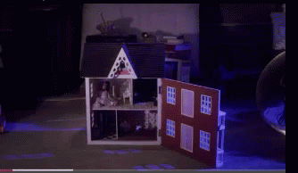 A Doll House With The Door Open And A Purple Light Behind It GIF