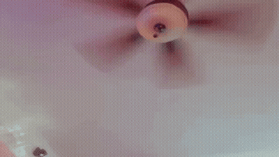 A Doll Is Being Held By A Person In A Bathtub And Being Played With . GIF