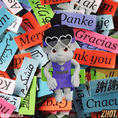 A Doll Wearing Sunglasses And A Zhotcita Shirt Stands In Front Of A Pile Of Colorful Stickers GIF