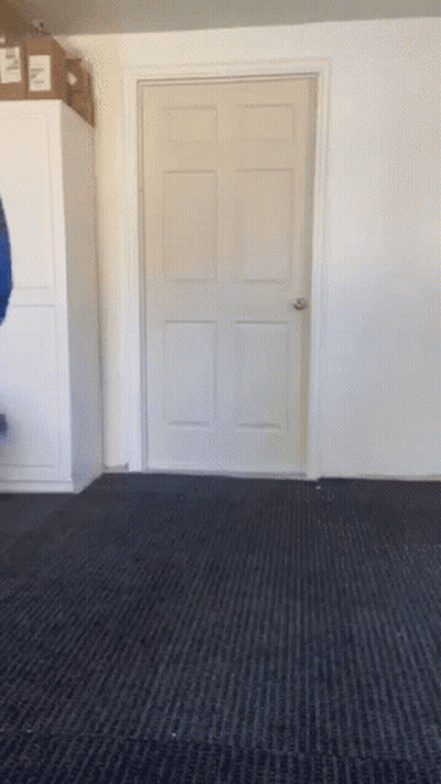 A Door In A Room With A Black Carpet And A Box On Top GIF