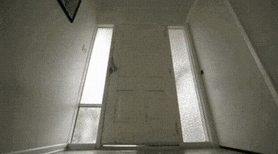 A Door That Is Open And Has A Picture On The Wall Above It GIF