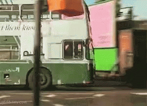 A Double Decker Bus With A Sign That Says " I Think I Know " GIF