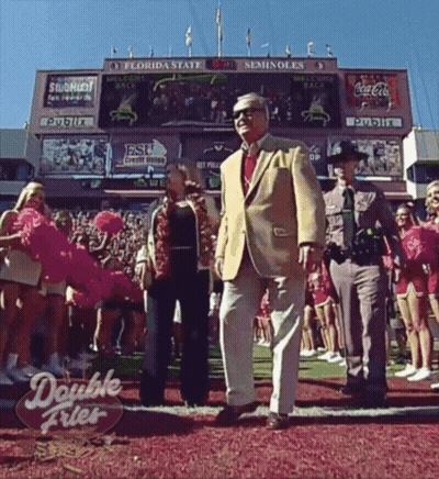 A Double Fries Sign Is On The Ground In Front Of A Florida State Football Stadium GIF