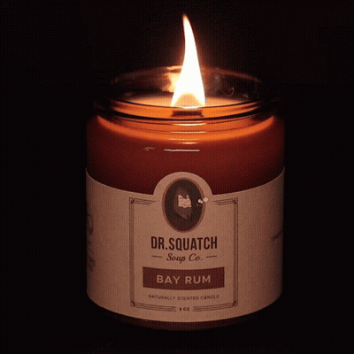 A Dr. Squatch Bay Rum Candle Is Lit Up GIF