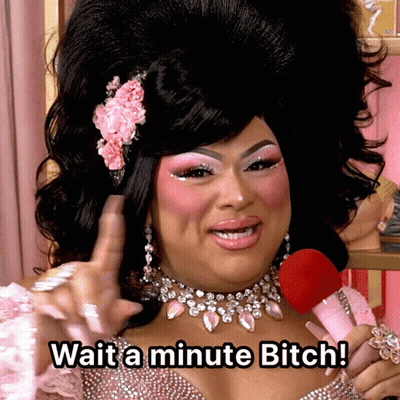 A Drag Queen Holding A Pink Microphone Says Wait A Minute Bitch GIF