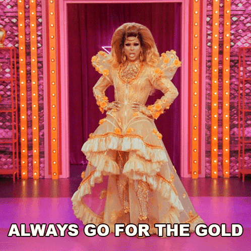 A Drag Queen In A Gold Dress With The Words Always Go For The Gold Underneath Her GIF