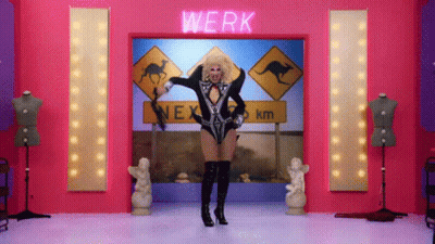 A Drag Queen Is Dancing In Front Of A Sign That Says Werk GIF