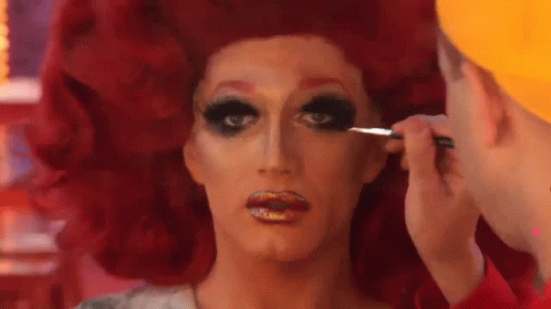 A Drag Queen Is Getting Her Makeup Done By A Man With A Brush . GIF