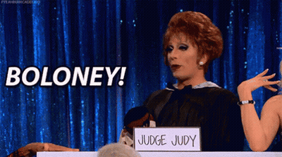 A Drag Queen Is Holding A Sign That Says Boloney GIF