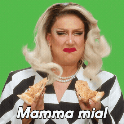 A Drag Queen Is Holding Two Slices Of Pizza With The Words Mamma Mia Written Above Her GIF