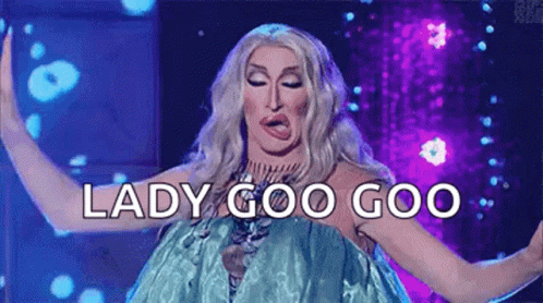 A Drag Queen Is Making A Funny Face And Saying `` Lady Goo Goo '' While Dancing On A Stage . GIF