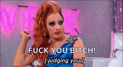 A Drag Queen Is Sitting On A Couch And Saying `` Fuck You Bitch ! Judging You '' . GIF