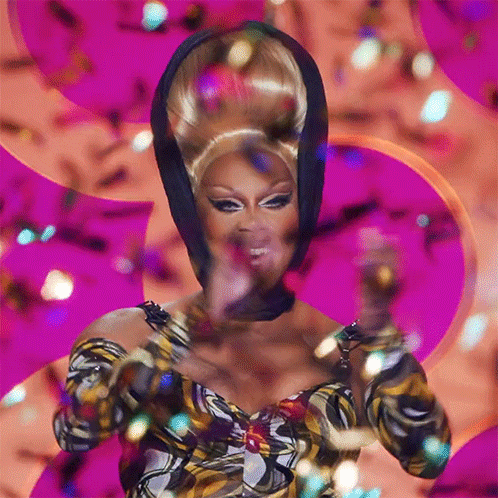 Drag Queen In Front Of Pink Background With Confetti GIF