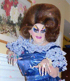 A Drag Queen Is Wearing A Blue Dress And Has A Very Large Wig On GIF