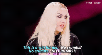 A Drag Queen Is Wearing A Yellow Feathered Headpiece And Earrings And Says This Is A Win For Me . GIF