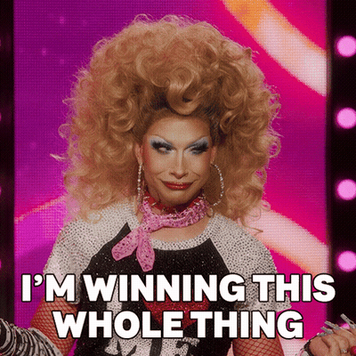 A Drag Queen Says " I 'M Winning This Whole Thing " On A Pink Background GIF