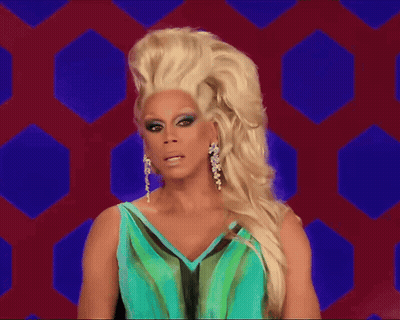 A Drag Queen Wearing A Blue And Green Dress GIF