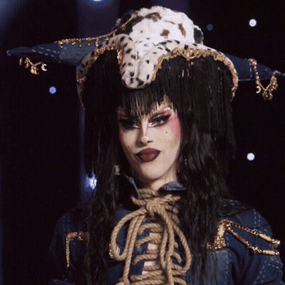 A Drag Queen Wearing A Dalmatian Hat Says " Evening Ma'am " GIF