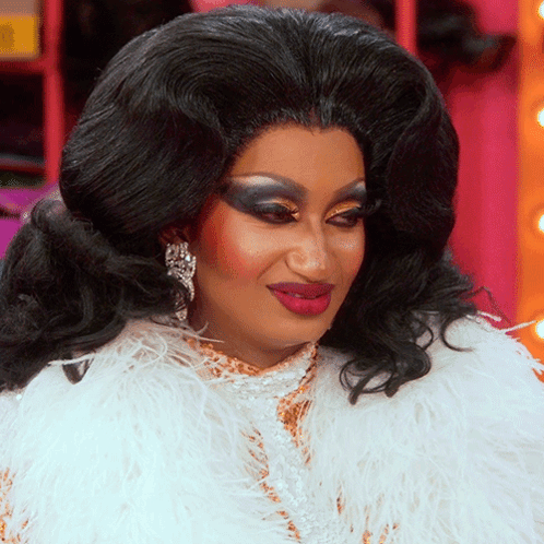 Drag Queen In White Feathered Coat And Earrings GIF