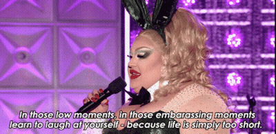 A Drag Queen Wearing Bunny Ears Is Singing Into A Microphone While Wearing A Bunny Costume . GIF