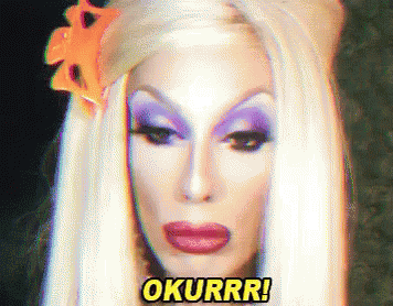A Drag Queen With A Flower In Her Hair Says Okurrr ! GIF
