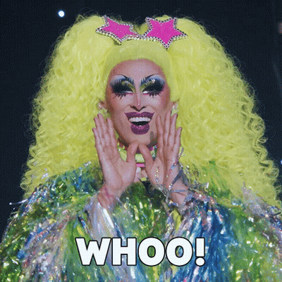 A Drag Queen With A Yellow Wig And A Pink Star On Her Head Says " Whoo " GIF