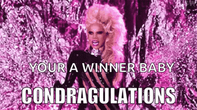 A Drag Queen With Pink Hair Is Standing In Front Of A Pink Background With The Words `` Your A Winner Baby Congratulatio GIF