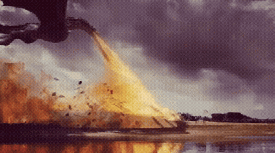 A Dragon Is Flying Over A Body Of Water And Throwing Fire Into The Air . GIF
