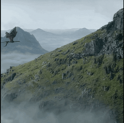 A Dragon Is Flying Over A Mountain Covered In Grass GIF