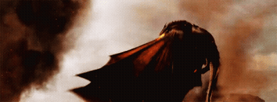 A Dragon Is Flying Through A Cloudy Sky With Smoke Coming Out Of It 'S Mouth . GIF
