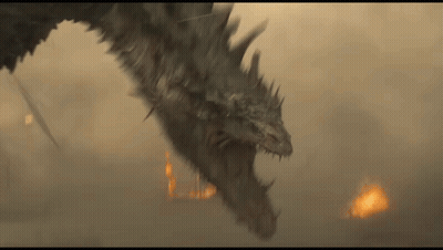 A Dragon Is Flying Through The Air With A Fire In The Background GIF