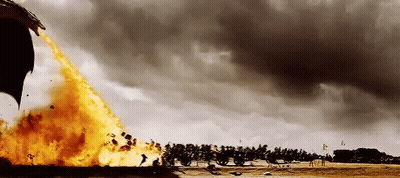 A Dragon Is Flying Through The Air With Flames Coming Out Of It 'S Tail . GIF