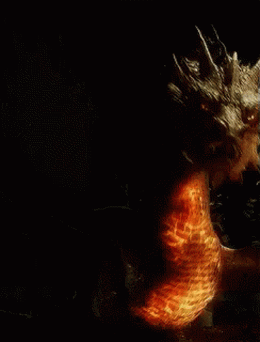 A Dragon Is Surrounded By Flames And Smoke GIF