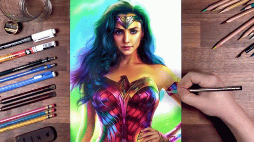 A Drawing Of Wonder Woman Is On A Table With Pencils And Pens GIF