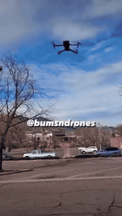 A Drone Is Flying Over A Parking Lot With The Words @Bumsnddrones Written On The Bottom GIF