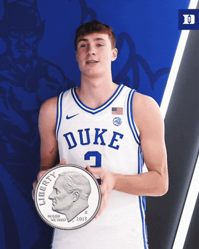 A Duke Basketball Player Holds A Liberty Coin GIF