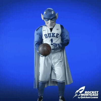 A Duke Basketball Player In A Superhero Costume Holds A Basketball GIF