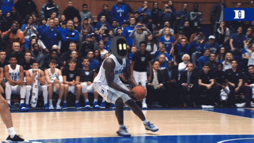 A Duke Basketball Player Is Dribbling A Basketball On The Court GIF