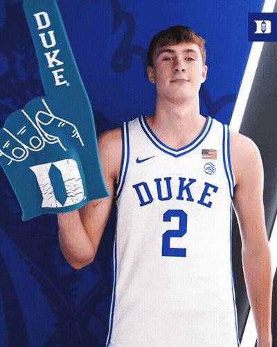 A Duke Basketball Player Is Holding A Blue Duke Foam Hand GIF