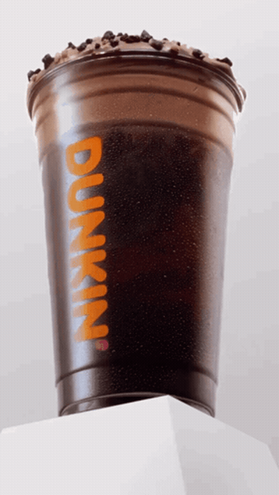 A Dunkin ' Cup With Iced Coffee And Chocolate Chips On Top GIF