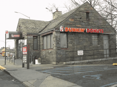 A Dunkin ' Donuts Building With A Handicapped Parking Spot GIF