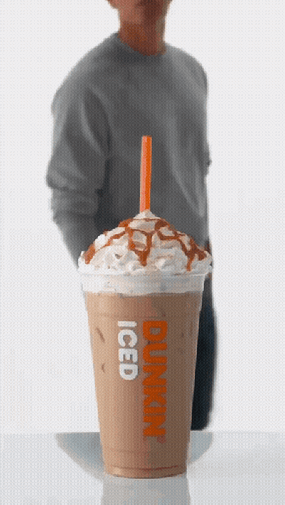 A Dunkin ' Donuts Iced Coffee With Whipped Cream And Caramel Sauce GIF