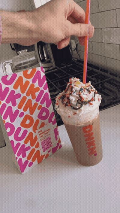 A Dunkin ' Donuts Milkshake With Whipped Cream And Sprinkles GIF