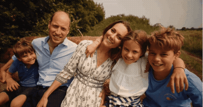 A Family Posing For A Picture With A Boy Wearing A Shirt That Says ' I Love You ' GIF