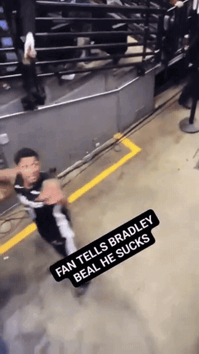 A Fan Tells Bradley Beal He Sucks While A Man Stands In The Background GIF